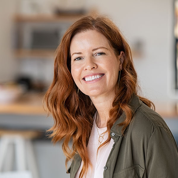 IV Sedation Woman with Red Hair Smiling Indoors