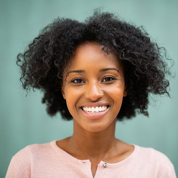 Oral Conscious Sedation Young Woman Smiling By Green Wall